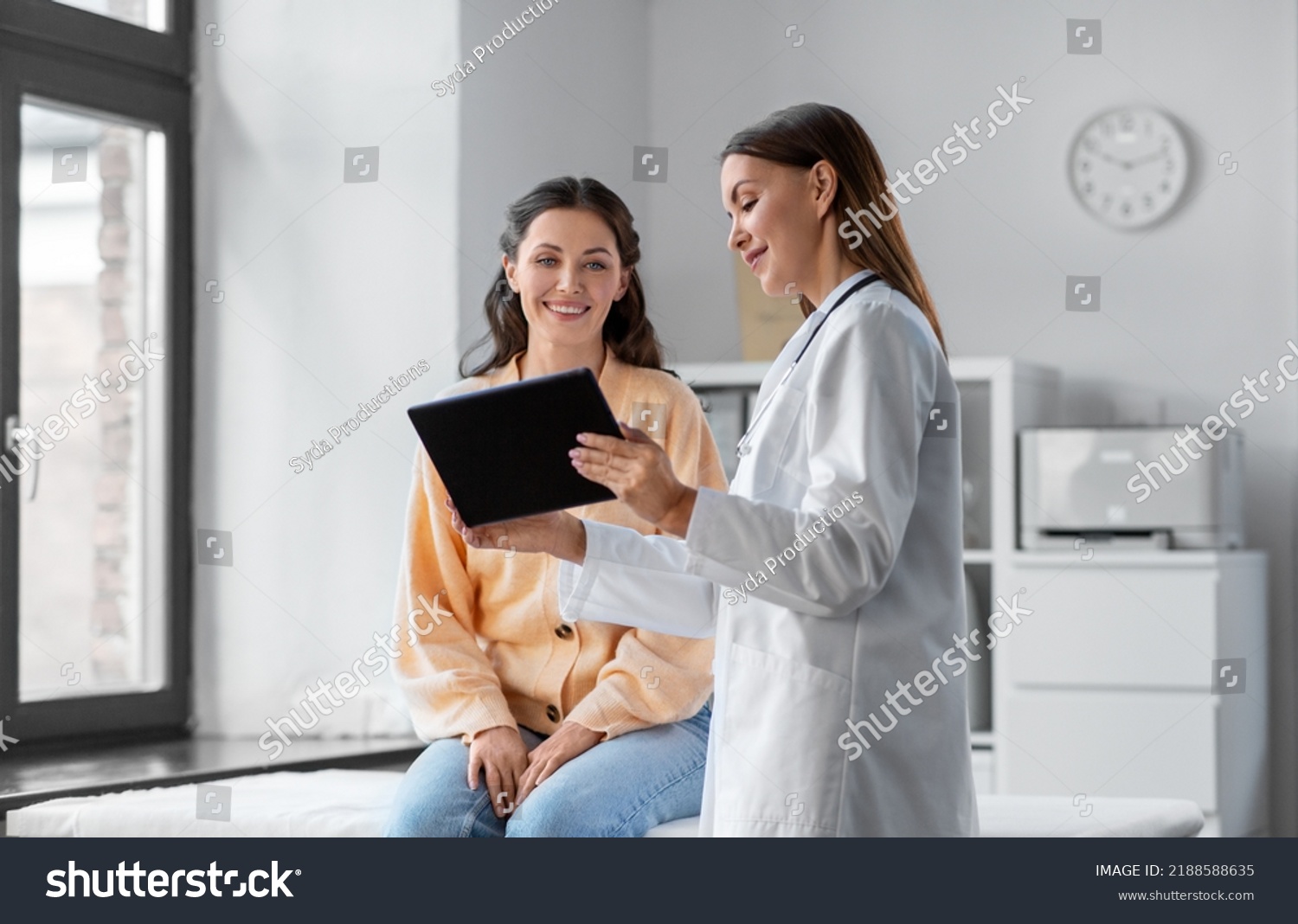stock-photo-medicine-healthcare-and-people-concept-female-doctor-with-tablet-pc-computer-talking-to-smiling-2188588635