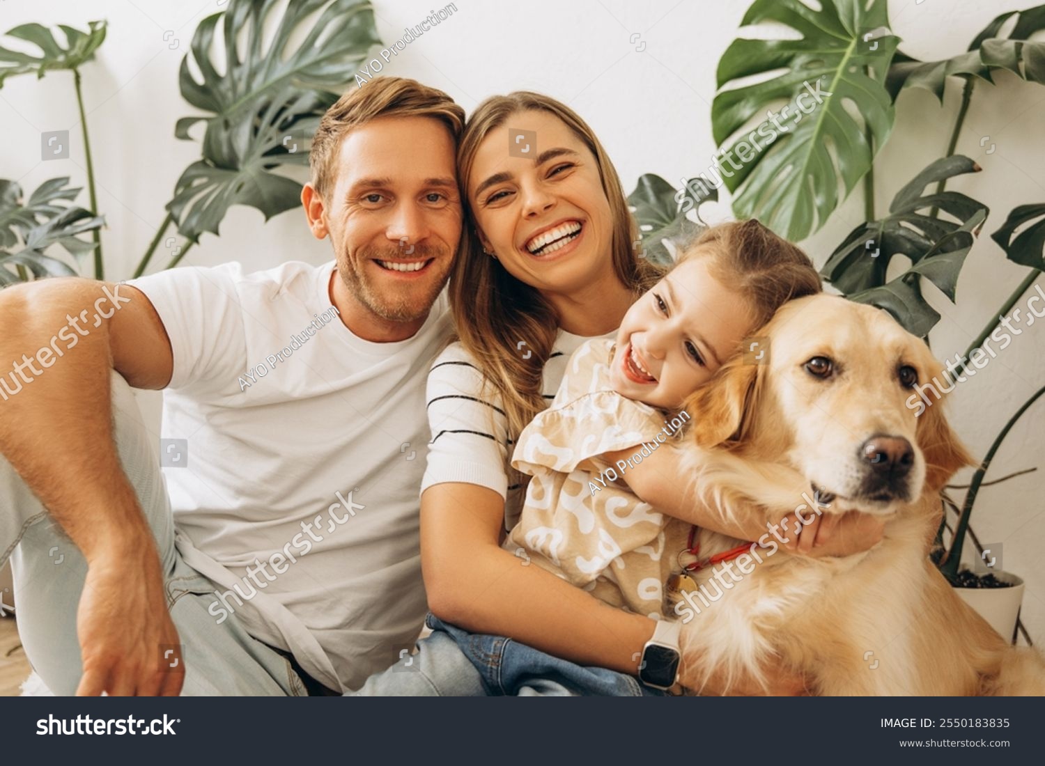 stock-photo-portrait-of-attractive-family-happy-mother-father-cute-little-daughter-hugging-together-with-2550183835
